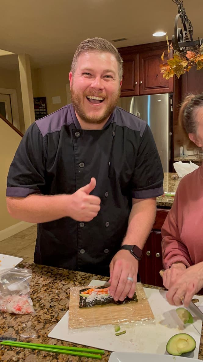 Chef teaching sushi techniques to the class