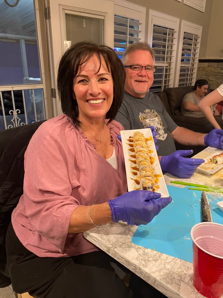 Friends working together at a sushi-making station