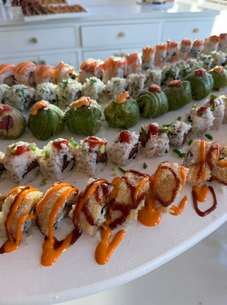 Sushi river detail with garnishes and fresh rolls