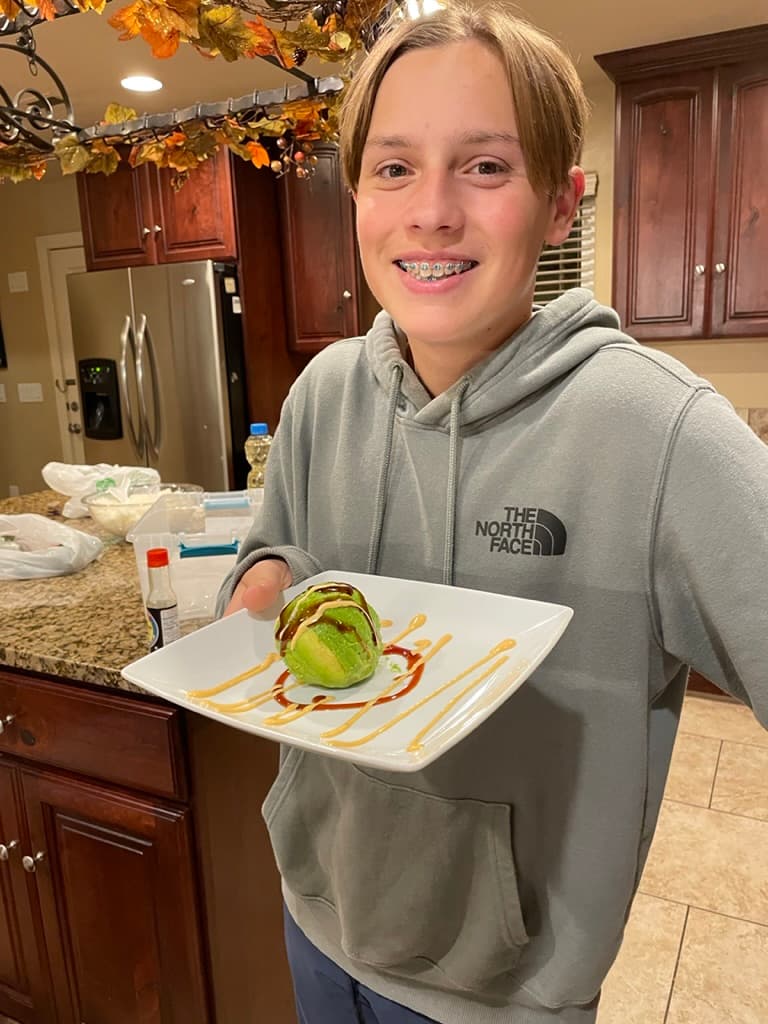 Guests laughing while learning to roll sushi
